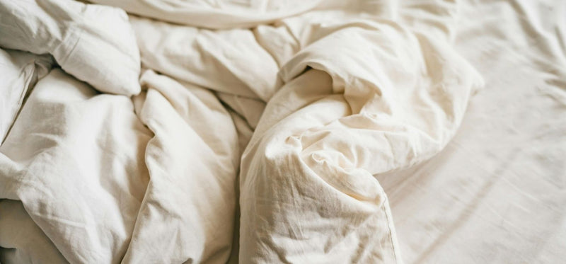 A close up image of messy bed sheets.