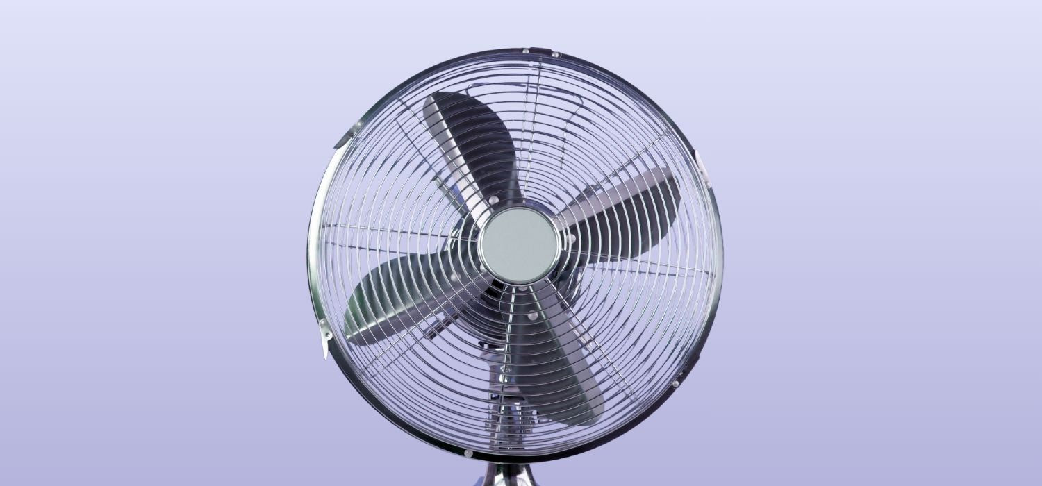 An image of a silver metal fan on a purple background.