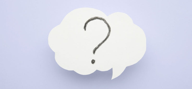 A clean, simple image of a white speech bubble containing a hand-drawn question mark on a light blue background.
