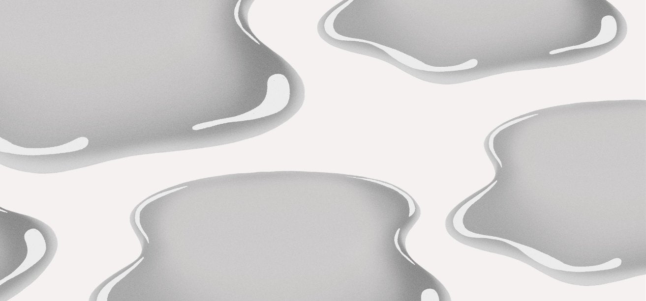 An illustration featuring glossy, liquid-like grey puddles or blobs on a solid white background.