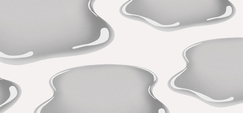 An illustration featuring glossy, liquid-like grey puddles or blobs on a solid white background.