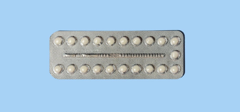 A silver blister pack containing 21 small white pills, centered on a solid light blue background.