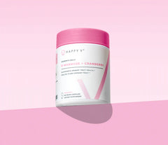 Happy V D-Mannose + Cranberry supplement bottle on a soft pink background, promoting urinary health.