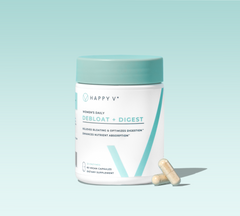 Happy V Debloat + Digest supplement bottle with two capsules on a light background.
