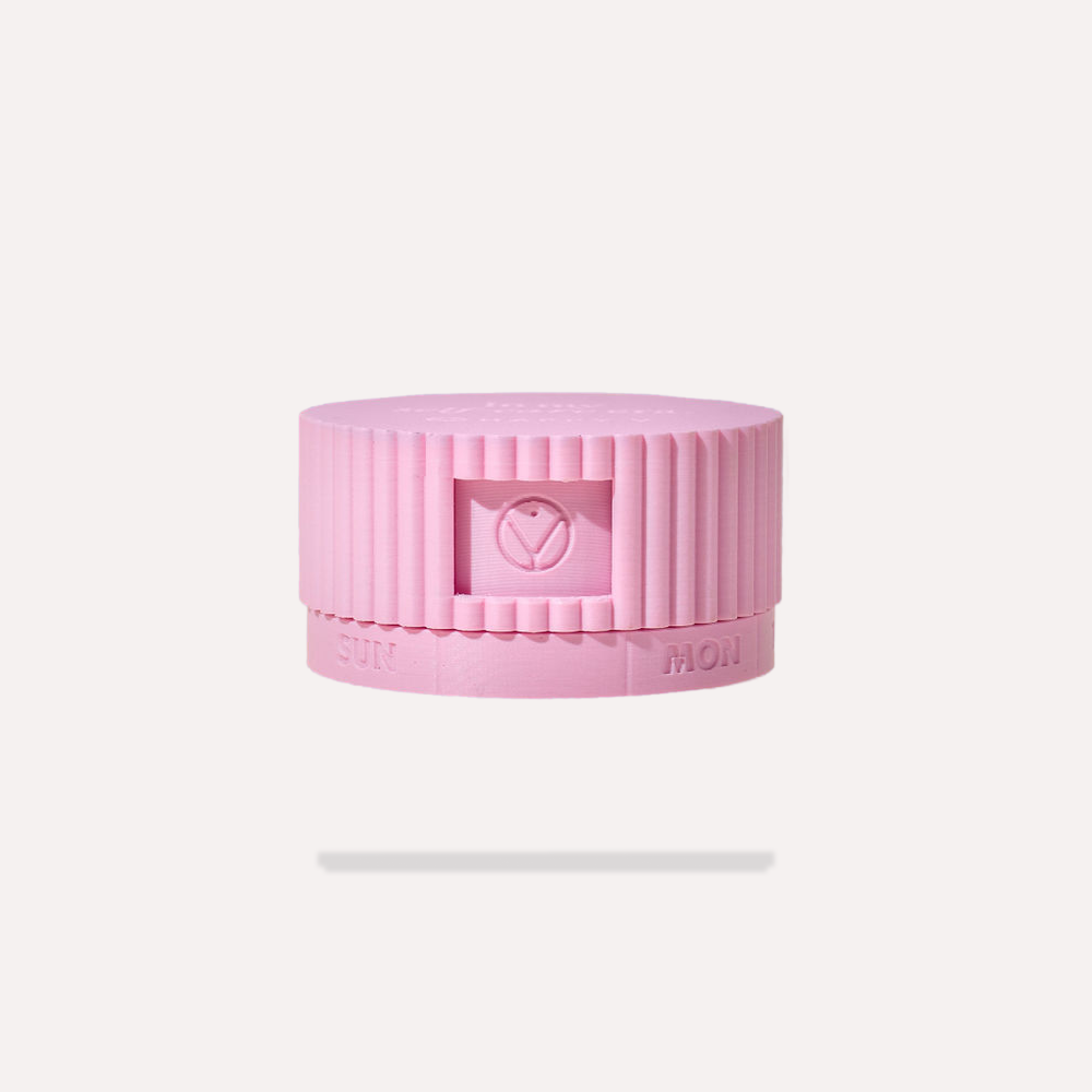 Pink round pill organizer with day labels, ideal for organizing Happy V supplements.