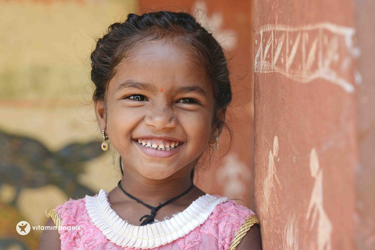 A young smiling girl, part of the Vitamin Angels campaign.
