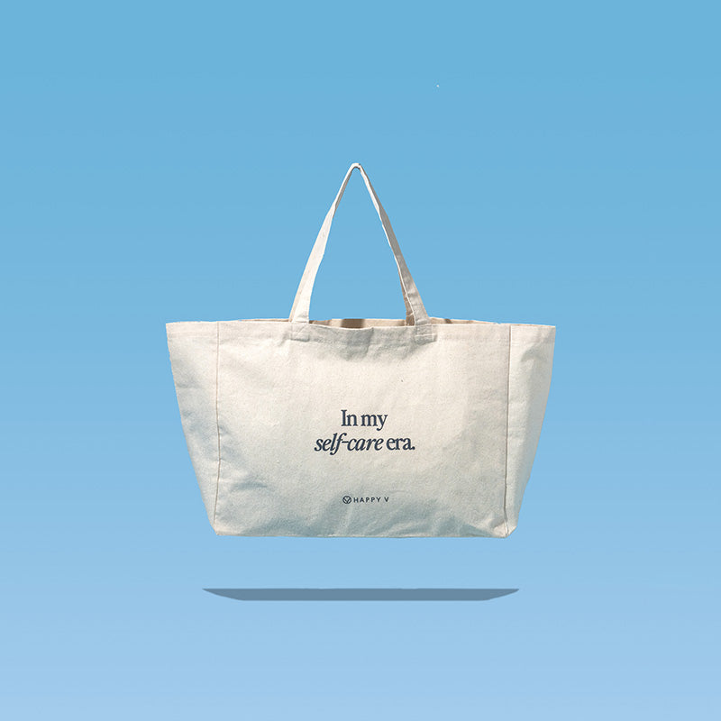 Tote bag featuring "In my self-care era" text, promoting Happy V's wellness ethos.