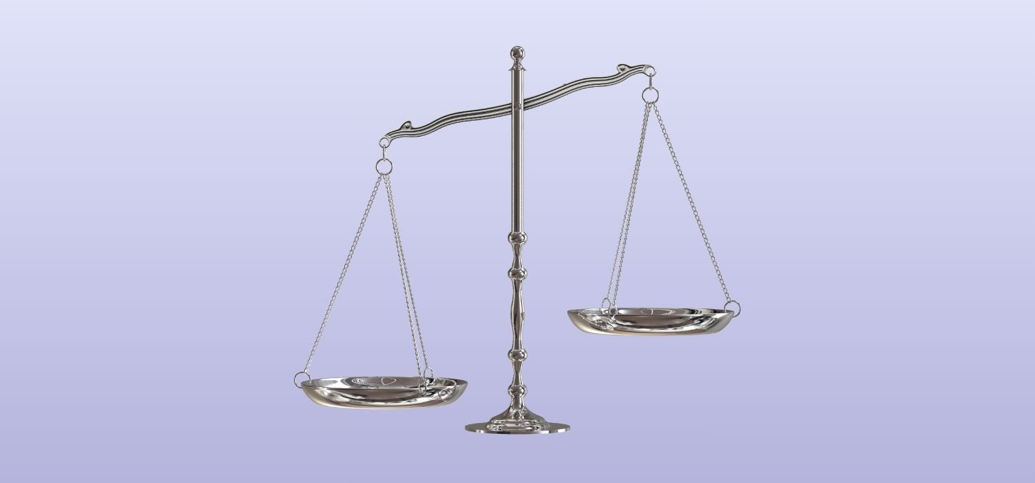 A silver balance scale showing an imbalance, set against a clean purple background.