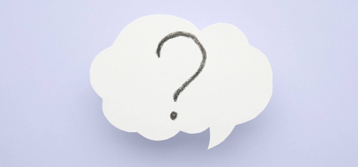 A clean, simple image of a white speech bubble containing a hand-drawn question mark on a light blue background.