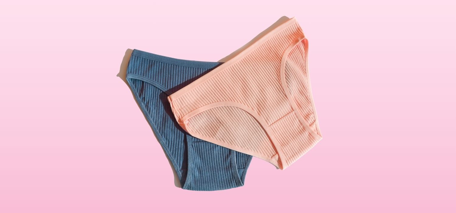 A close up image of two pairs of women's underwear against a pink background.
