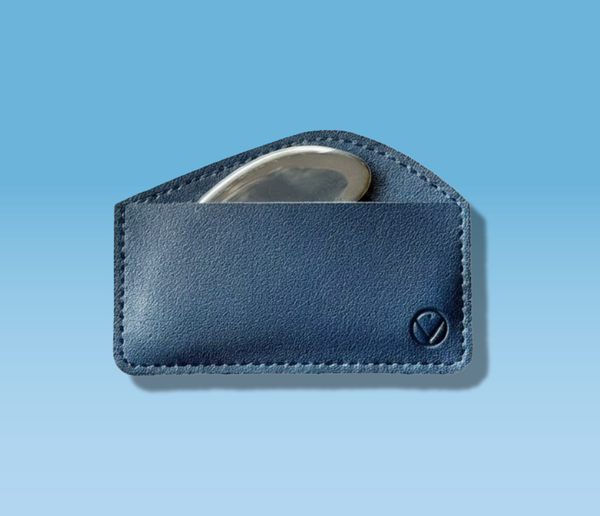 Navy leather wallet with a silver compact mirror inside, designed for women's wellness.