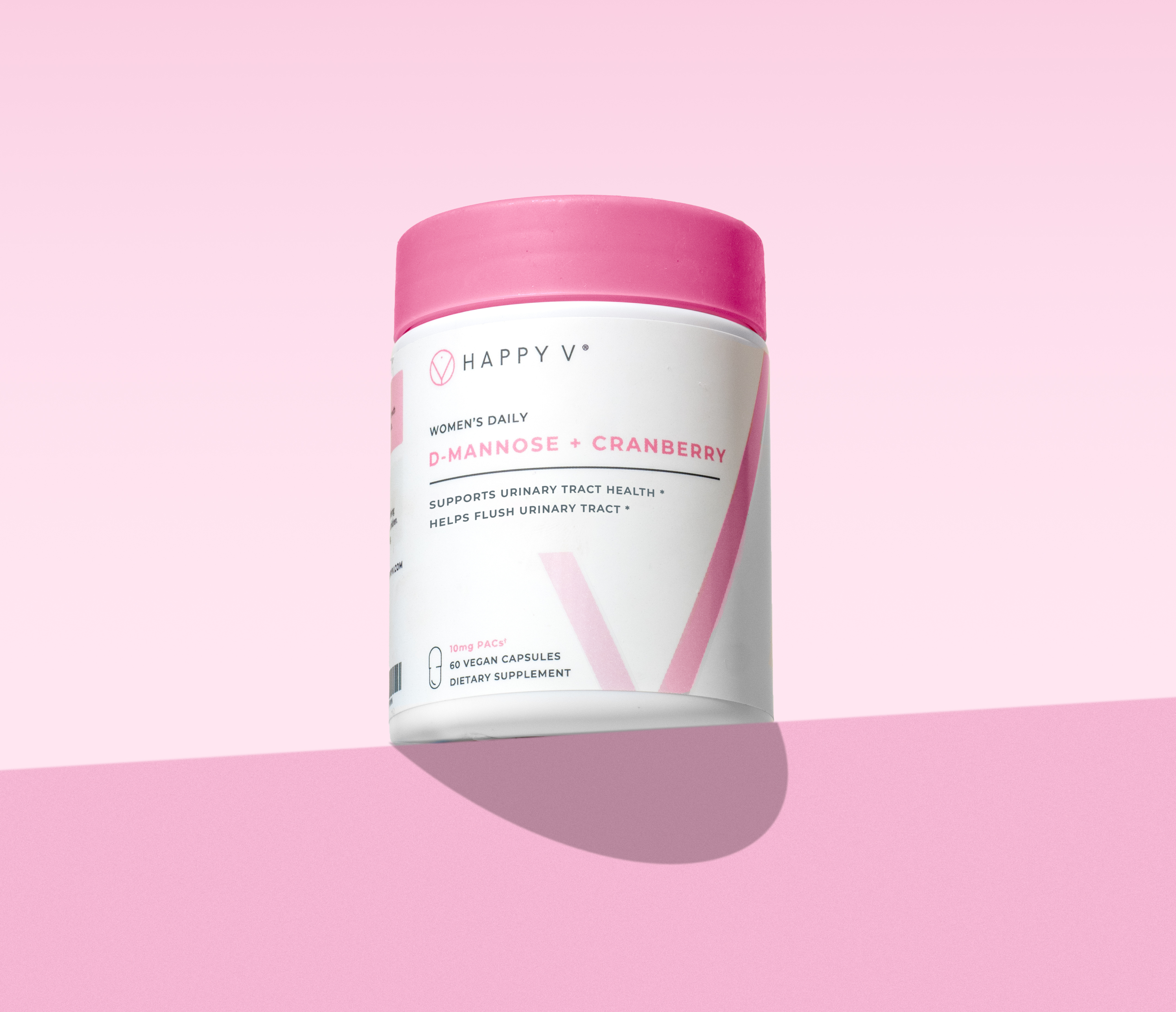 Happy V D-Mannose + Cranberry supplement bottle on a soft pink background, promoting urinary health.