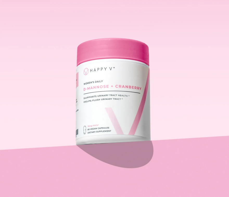 D-Mannose + Cranberry supplement bottle with pink lid on a white background.