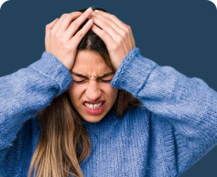 Woman in a blue sweater appears to be holding her head with both hands in frustration.