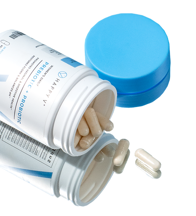 Probiotic supplement bottle from Happy V with capsules spilling out onto a surface.