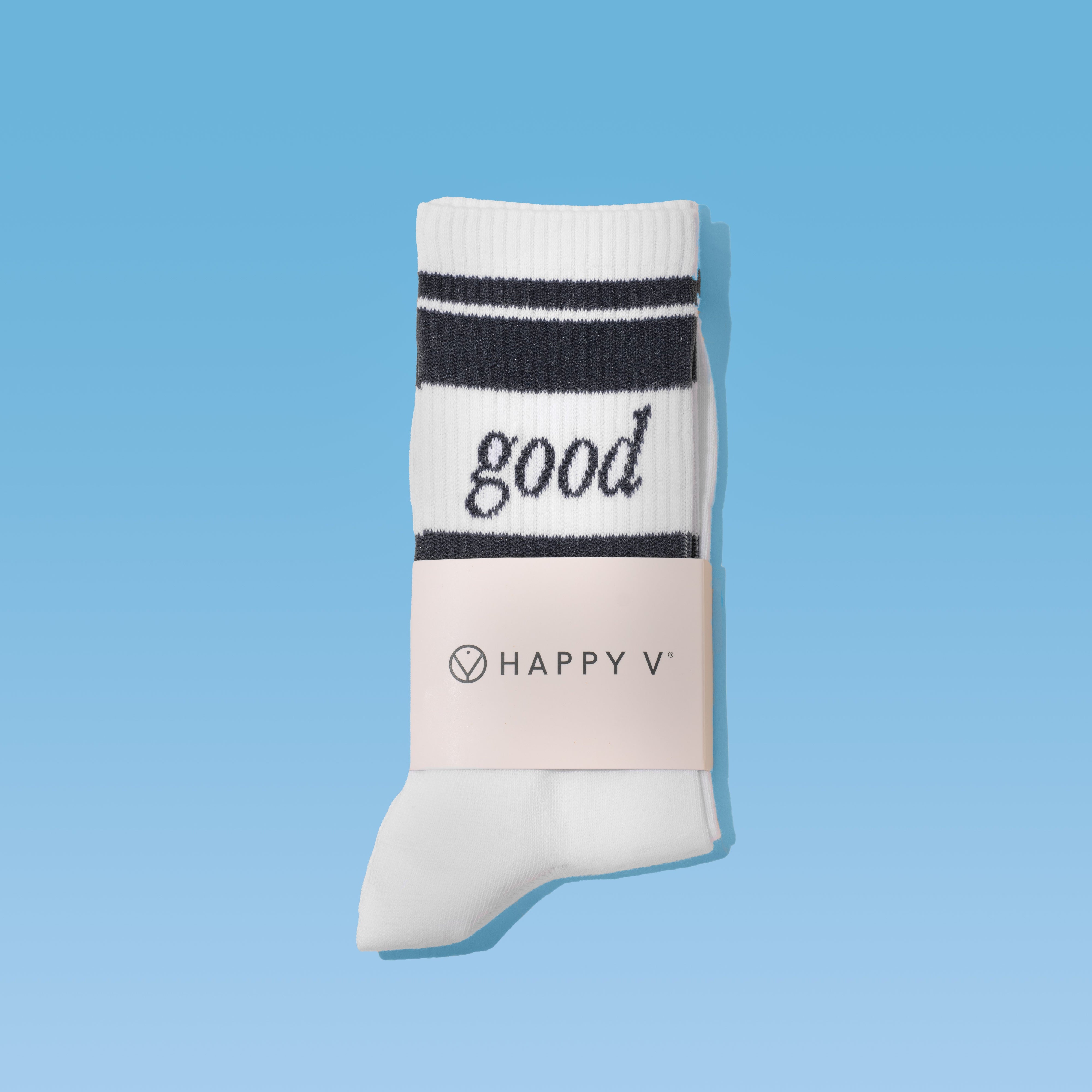 White sock with "good" text next to Happy V supplement packaging on blue background.