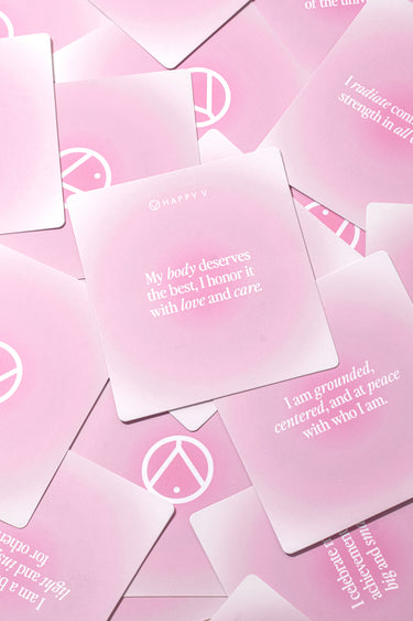 Pink affirmation cards with positive messages, promoting wellness alongside Happy V supplements.