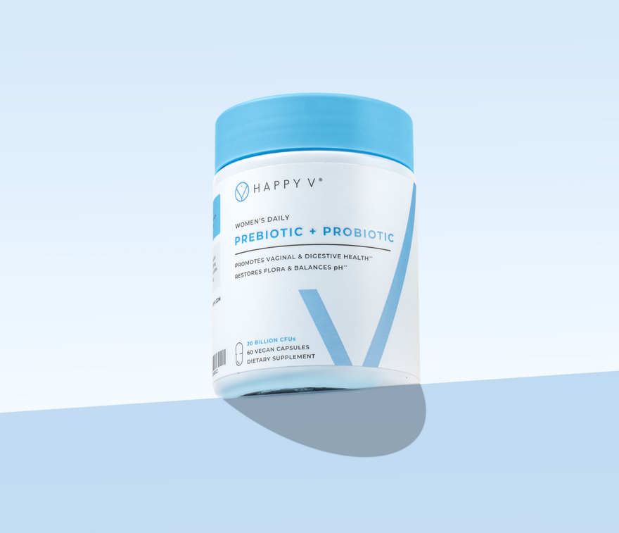 Women’s daily prebiotic and probiotic supplement in a blue and white container on a light blue background.