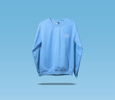 The front side of a Happy V Crewneck Sweatshirt in blue against a blue background.