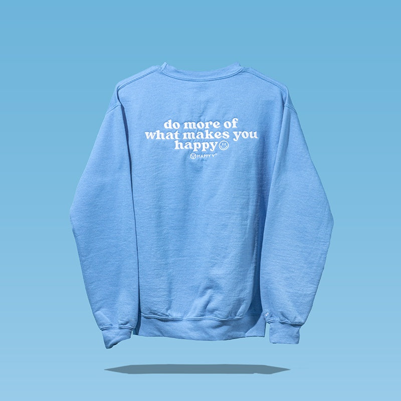 Blue sweatshirt saying “do more of what makes you happy,” reflecting wellness.