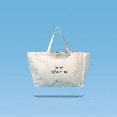Tote bag featuring "In my self-care era" text, promoting Happy V's wellness ethos.