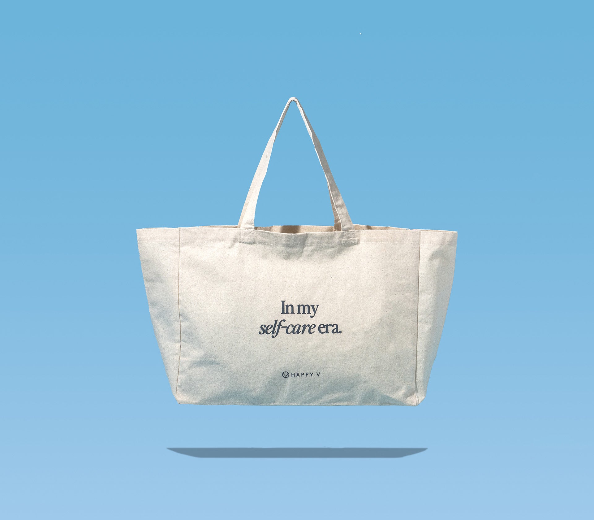 Happy V Tote Bag on a blue background.
